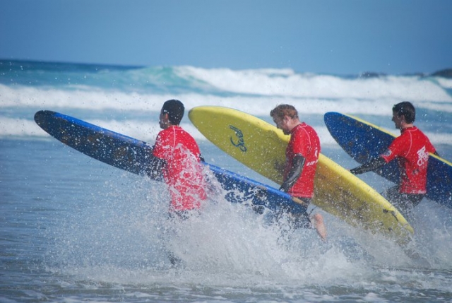 Three friends surfing the waves